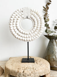 Embellished with crisp white moon shells, intricately sewn onto a thick crochet backing, Our Koko designs are a gorgeous versatile feature made to suit any modern space & inject a coastal vibe.  White Coastal Decor, Papua Shell Tribal Necklace, standing decor, coastal white modern decor. Homewares Melbourne. Sale Now On