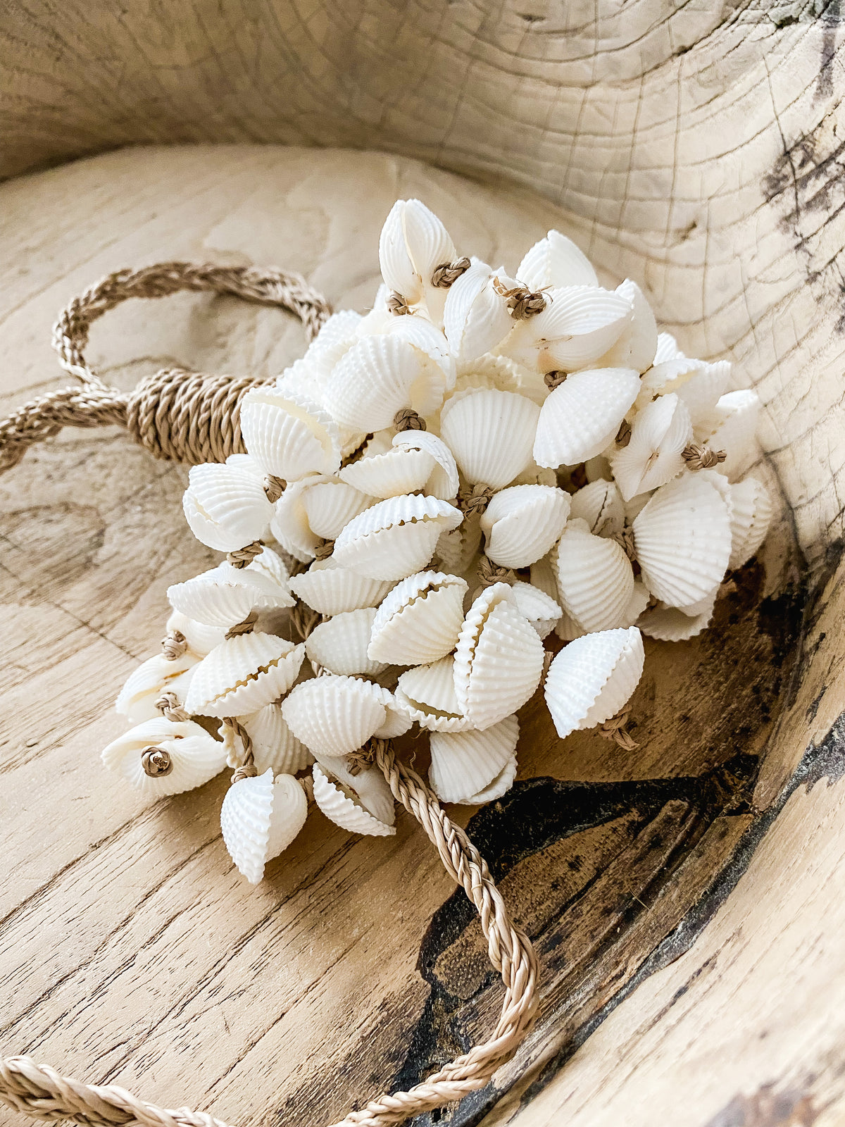 A cluster of natural scallop shells carefully strung together from a braided Jute base.   These gorgeous tassels can hang from a wall hook, door knob or be draped over a shelf. Simply place on a stack of books on a side table, use over a decorative bowl or add to an existing centrepiece on your hall or coffee table to level up your styling game.  