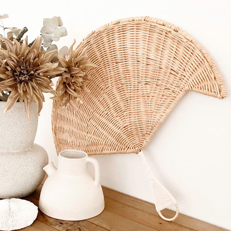 A beautifully handwoven quality rattan fan shaped wall Hanging generously sized and perfect for filling that empty wall space. Unlike common palm leaf variations typically used for their versatile & bendable body, this piece has been made with furniture grade rattan, is not flexible & is specifically designed for use as a wall hanging or styling accessory.