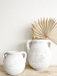 Add ancient charm to your space with our stunning Zahra Urns in Rustic White. The distressed look of this piece adds vintage decorative aspects and antique style. Two handles for easy manoeuvrability and a selection of coordinates to pair with throughout your home.