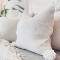 Handwoven in Morocco these gorgeous crisp white Pom Pom cushions are made using 100% of the highest quality cotton. Compatible with bedroom and living room spaces. Check out our range of matching Throwrugs, Soft furnishings, homewares and decor for Neutral Moroccan Boho & Coastal living   